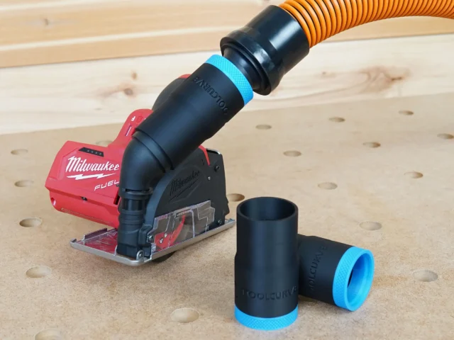 Black 1-1/4" hose adapter with blue cuff joining an orange hose to a Milwaukee M12 Fuel cut out tool, spare adapters alongside