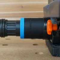 Black ToolCurve 1-7/8 inch hose adapter with blue band joining a vacuum hose to a Wen sander dust port