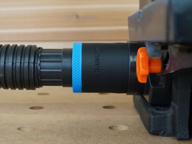 Black ToolCurve 1-7/8 inch hose adapter with blue band joining a vacuum hose to a Wen sander dust port