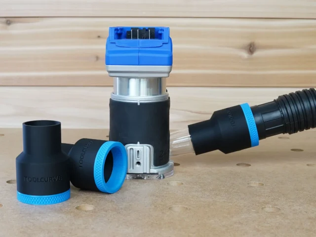 Black 1-7/8 inch hose adapter with blue collar joining a vacuum hose to a Kobalt 24v router, plus a spare adapter