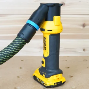 Black hose adapter with blue 27mm band on a Dewalt cut out tool, linking dust port to a vacuum hose