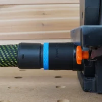 Black ToolCurve 36mm hose adapter with blue band joining a green hose to a Wen belt and disc sander dust port