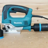 Black 36mm ToolCurve hose adapter with blue band shown loose and connected to a Makita jig saw dust port