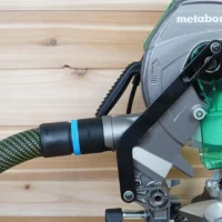 Black ToolCurve 36mm hose adapter with blue band joining a braided hose to a Metabo HPT miter saw dust port