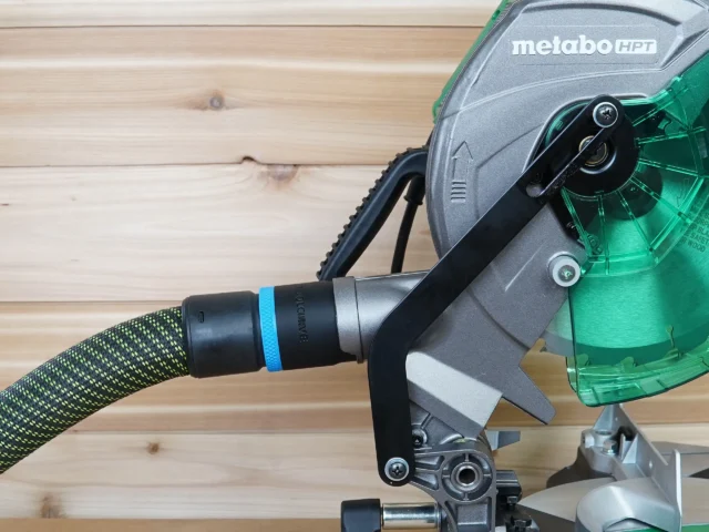 Black ToolCurve 36mm hose adapter with blue band joining a braided hose to a Metabo HPT miter saw dust port