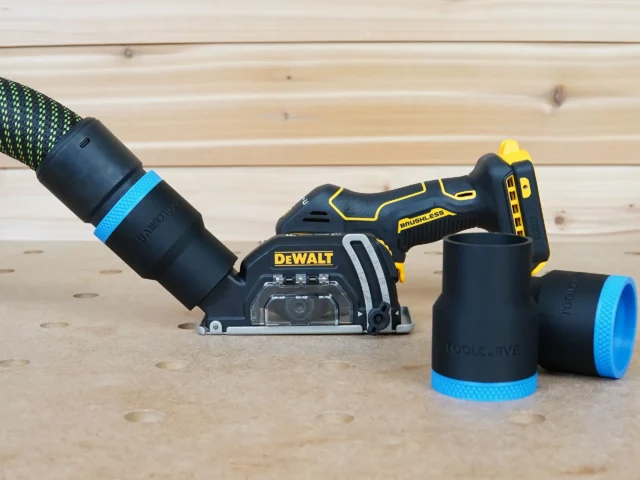 Black 36mm ToolCurve hose adapter with blue band joining a vacuum hose to a DeWalt cut-out tool dust port, two spare adapters beside it