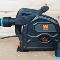 Black ToolCurve 1-7/8 inch hose adapter with blue band joining a vacuum hose to a Wen track saw dust port, second adapter beside it