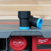 Black ToolCurve hose adapter with blue grip ring, mounted on Milwaukee M18 table saw dust port