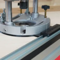 Guide rail adapter mounted on Dewalt DWE625 plunge router, attached to a Festool track saw rail