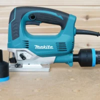 Black 1-7/8 inch hose adapter with blue band fitted to a Makita jig saw dust port, second adapter beside it
