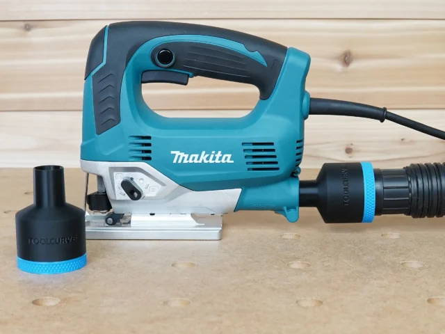 Black 1-7/8 inch hose adapter with blue band fitted to a Makita jig saw dust port, second adapter beside it