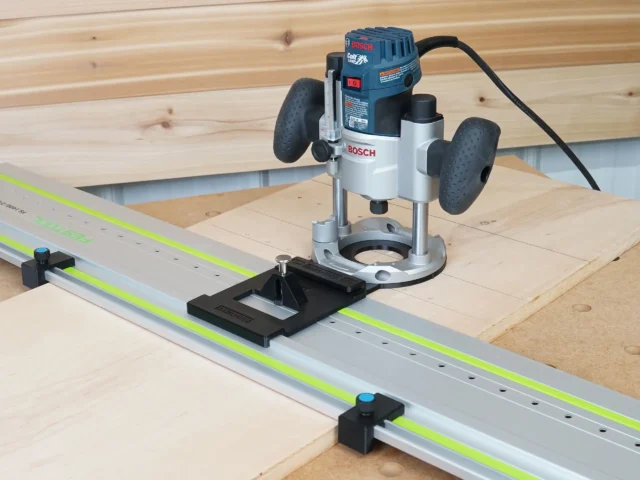 Black LR32 rail adapter with plunge base attached to Bosch Colt router mounted on guide rail with Festool track, showing stop blocks and registration plate