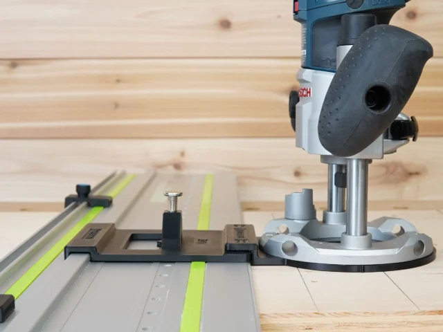 Bosch Colt plunge router mounted on LR 32 rail system with adapter and stop blocks on Festool track, ready for hole drilling