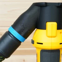 Black hose adapter with blue band attached to yellow Dewalt drywall cut out tool dust port