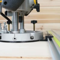 Guide rail adapter for Dewalt 625 router mounted on router base with track saw guide rail visible