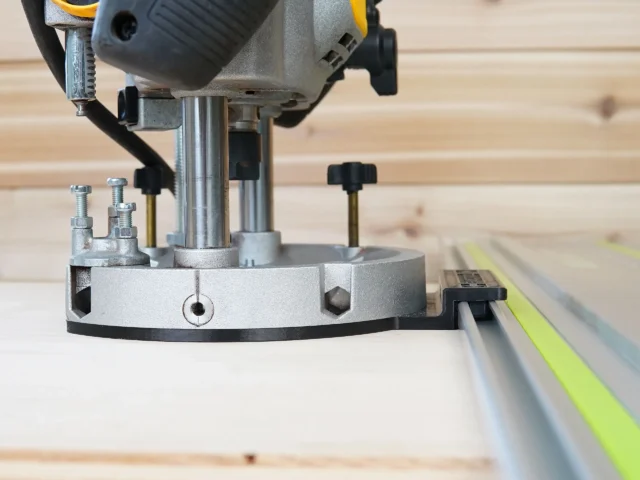 Guide rail adapter for Dewalt 625 router mounted on router base with track saw guide rail visible