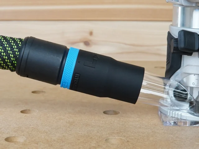 Black hose adapter with blue band attached to Kobalt 24v router dust port, connected to Festool hose