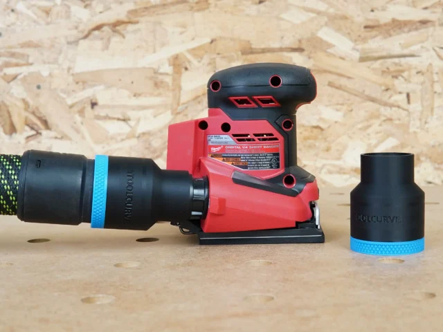Black ToolCurve 36mm hose adapter with blue band joining a vac hose to a Milwaukee 1/4 sheet sander, plus a spare adapter