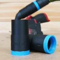 Black ToolCurve hose adapter with blue textured ring, shown alone and attached to Milwaukee 12v Cut Out Tool in background