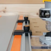 Two black limit stops with orange knurled knobs mounted on a Wen guide rail, positioned at different points along the track
