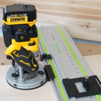 DeWalt 20V router mounted on LR 32 plunge base attached to Festool guide rail with positioning knob and rail stops