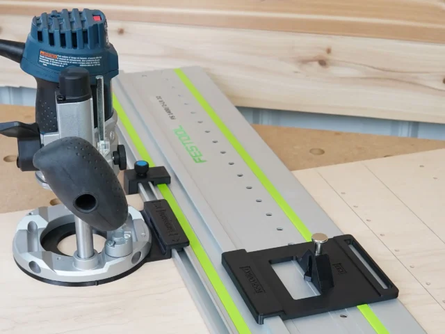 Bosch Colt plunge base router mounted to Festool LR 32 guide rail with black adapter plate and spring-loaded positioning knob installed