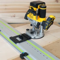 DeWalt 20V router mounted on LR32 plunge base with guide rail and positioning stops on wooden workpiece