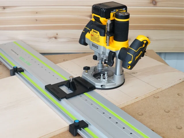 DeWalt 20V router mounted on LR32 plunge base with guide rail and positioning stops on wooden workpiece
