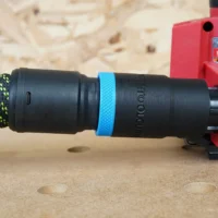 Black hose adapter with blue band attached to Milwaukee 18v Sheet Sander, showing Festool 27mm hose connected on the left