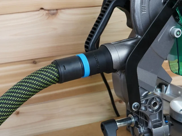 Black hose adapter with blue band attached to Metabo HPT miter saw dust port, connected to green and yellow braided hose