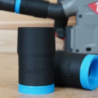 Black ToolCurve hose adapter with blue grip band, shown alongside a Milwaukee track saw in background