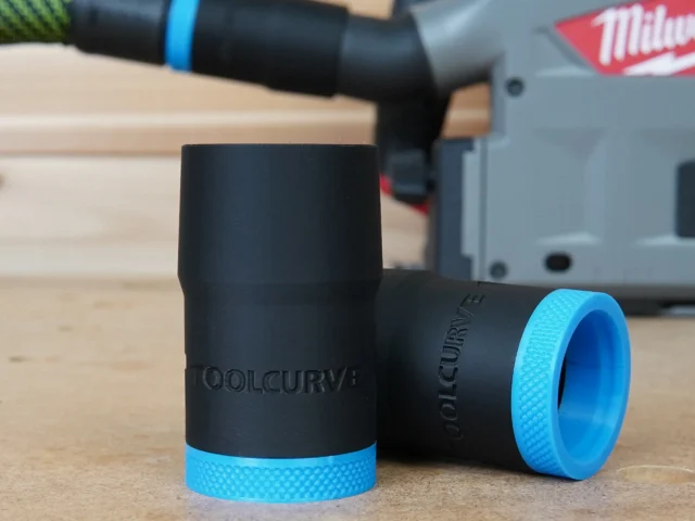 Black ToolCurve hose adapter with blue grip band, shown alongside a Milwaukee track saw in background