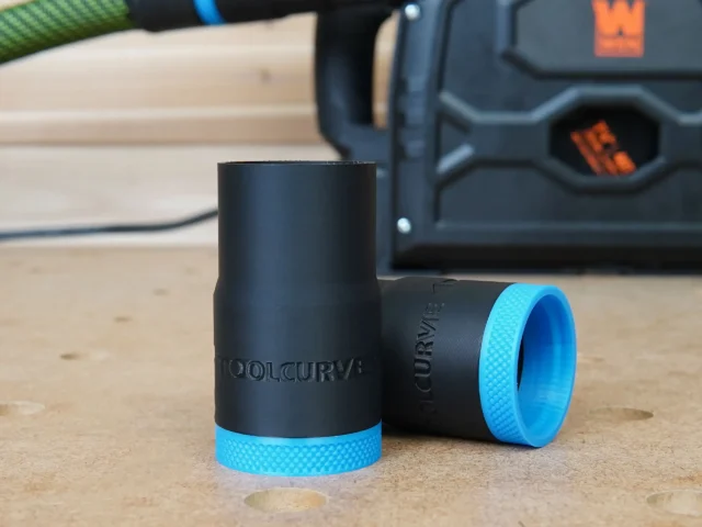 Black ToolCurve hose adapter with blue grip band, shown standalone and installed on Wen track saw dust port in background