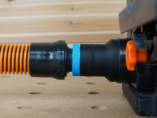 Black 1-1/4 inch hose adapter with blue grip ring joining an orange vacuum hose to a Wen sander dust port