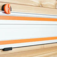 Orange and black wall mount attached to Wen track saw rail mounted on wooden wall