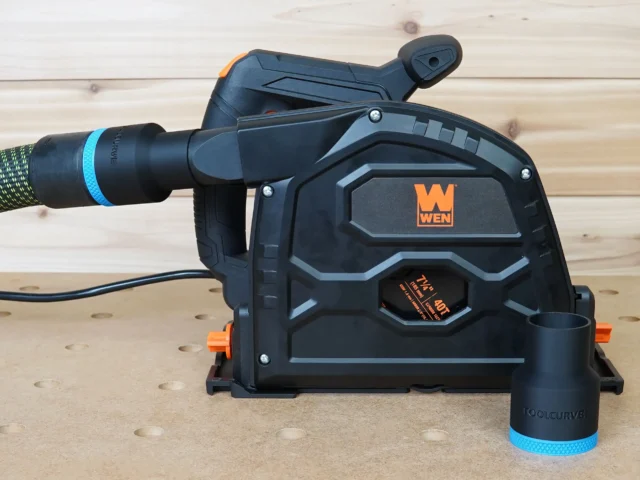 Black ToolCurve 36mm hose adapter with blue band on a Wen track saw dust port, second adapter attached to hose