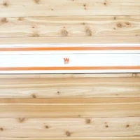 Wen track saw rail mounted on wooden wall with orange end caps and black locking handles on both sides