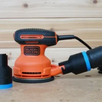Black 36mm ToolCurve hose adapter with blue band beside a Black+Decker sander, second adapter joining hose to dust port