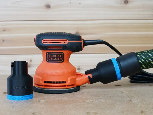 Black 36mm ToolCurve hose adapter with blue band beside a Black+Decker sander, second adapter joining hose to dust port