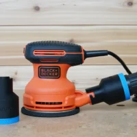 Black ToolCurve 1-7/8 inch hose adapter with blue band shown beside and fitted to a Black+Decker sander dust port