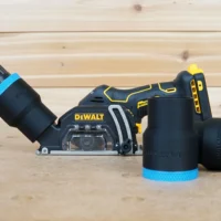 Black ToolCurve 1-7/8 inch hose adapter with blue band fitted to a DeWalt cut out tool, plus two spare adapters