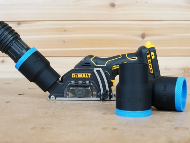 Black ToolCurve 1-7/8 inch hose adapter with blue band fitted to a DeWalt cut out tool, plus two spare adapters