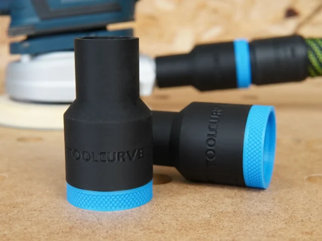 Three black hose adapters with blue grip bands labeled ToolCurve, shown standing and laying on a workbench