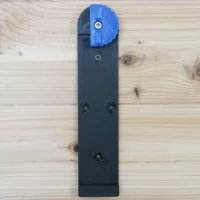Black wall mount for Kreg ACS track rails with blue locking lever and four screw holes for installation