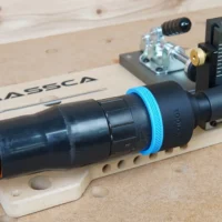 Black 2-1/2" hose adapter with blue collar joining an orange dust hose to a Massca pocket hole jig port