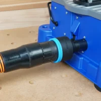 Black ToolCurve 2-1/2 inch hose adapter with blue collar linking an orange hose to the Kreg Foreman rear dust port