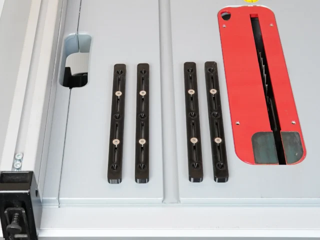 Four black adjustable miter bars with countersink holes and metal pivot points, displayed on a white surface next to a red plastic accessory
