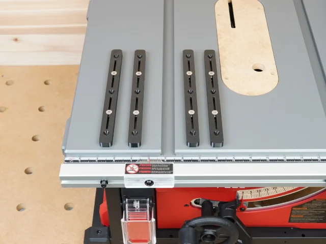 Four black adjustable miter bars mounted on a Milwaukee table saw fence, with a natural wood template above showing mounting hole positions
