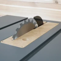 MDF zero clearance insert installed in a SawStop compact table saw with blade and riving knife raised through the slot