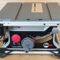 Zero clearance MDF insert installed in SawStop Compact table saw, with light wood insert visible and blade slot centered